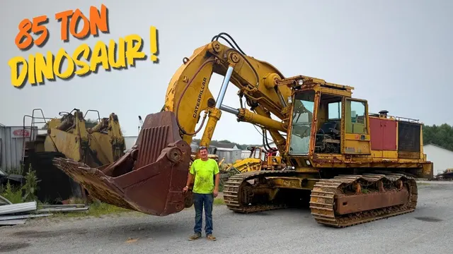 Matt beside an 85-ton Caterpillar 245 shovel in a yard