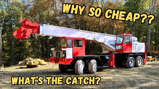 Red and white truck crane bought at auction