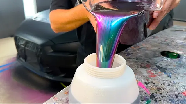 Color-shifting HyperShift paint poured from a cup, shimmering pink, green and gold